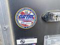 A sticker on a trailer indicating compliance with NATM guidelines featuring the text NATM National Association of Trailer Manufacturers and a barcode along with a serial number B18 186623