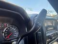 Close-up of the dashboard and steering wheel controls of a 2016 GMC Sierra 1500 showing speedometer and gear shift lever