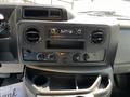 Dashboard of a 2021 Ford Econoline featuring a radio display and control knobs for air conditioning and ventilation