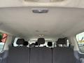 Interior view of a 2017 Ford Transit van showing the ceiling and rows of black upholstered seats with headrests