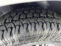 Close-up of a tire from a 2019 Mercedes-Benz Sprinter showcasing a rugged tread pattern and details of the rubber surface