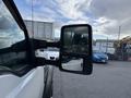 Side view mirror of a 2008 Ford F-450 showing its reflective surface and sturdy black frame