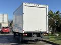 A white 2014 Hino 195 box truck viewed from the rear with a smooth surface and no visible markings or graphics