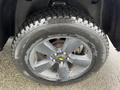 Close-up of a tire on a 2019 RAM 1500 Classic featuring a black alloy wheel with five spokes and a rugged tread pattern