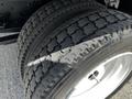 Close-up of a 2016 Isuzu NQR rear tire showing tread pattern and white rim