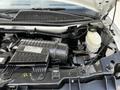 Close-up view of the engine compartment of a 2015 Chevrolet Express showing the air intake system and various engine components