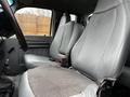 The interior of a 2013 Ford F-650 featuring gray leather seats with a center console and seatbelt on the passenger side