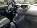 Interior view of a 2016 Ford Transit Connect showcasing the driver's seat steering wheel gear shifter and dashboard controls