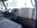 Interior view of a 2014 International Durastar showing the driver's side dashboard and seat with controls and storage compartments visible
