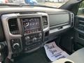 Interior dashboard of a 2021 RAM 1500 featuring a touchscreen display with controls for audio and climate settings and a gearshift console