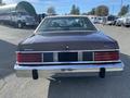 A bronze 1982 Mercury Grand Marquis viewed from the rear showcasing its distinctive taillights and chrome bumper