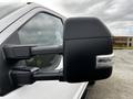 Close-up of the side mirror of a 2020 Ford F-250 SD showcasing its black casing and integrated turn signal