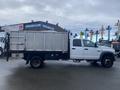 A white 2008 Dodge Ram 5500 with a flatbed and a metal side dump body shown from the side