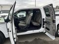 A 2017 Ford F-150 with its front door open revealing a spacious interior featuring gray seating and various controls