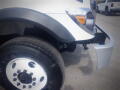 A 2016 International WorkStar 7500 with a partially visible front and wheel showcasing its tire and fender design