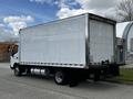 A 2018 Hino 195 truck with a large white cargo box and visible rear wheels parked on a street