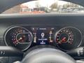 Dash view of a 2020 Jeep Wrangler displaying the speedometer tachometer and warning lights with a digital odometer reading 74650 km