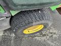A close-up of a tire from a 2014 John Deere 1585 Terrain Cut featuring a textured tread and a yellow rim