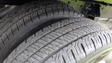 Close-up of two tires from a 2018 Ford Transit showing tread patterns and detailing of the rubber surface