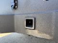Close-up of a 2023 Ford F-550's rear bumper featuring a square receiver hitch opening and textured black surface