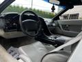 Interior view of a 1992 Chevrolet Corvette featuring gray leather seats and a dashboard with gauges