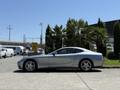 A silver 2005 Ferrari 612 Scaglietti sports car parked with sleek lines and a coupe silhouette featuring five-spoke alloy wheels
