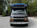 Front view of a 2019 Chevrolet Express with a black and silver body and a blue hood
