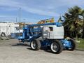 A blue 2012 Genie Z 45/25 articulated boom lift with large tires and a distinctive basket for reaching high areas
