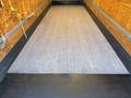 Interior view of a 2015 Freightliner M2 106 truck box showing wooden flooring and rubber edge flooring with a loading ramp at the back