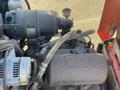 Close-up view of a 2010 Kubota F3680 engine showcasing various components including an alternator air filter and exhaust manifold