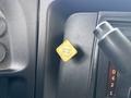 A yellow parking brake release lever inside a 2013 International 4300 cab