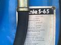 A metal identification plate for a 1997 Genie S-65 4X4 with specifications including weight capacity platform height and other details