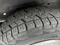 Close up of a tire from a 2008 Ford Econoline showing tread patterns and rubber texture