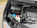 A 2014 Honda Odyssey with an engine compartment showcasing various components including fluid reservoirs and hoses
