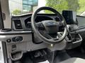 Interior of a 2022 Ford Transit showing the steering wheel dashboard and touchscreen display with various controls and settings