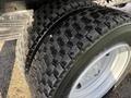 Close-up of two treaded tires mounted on a white rim suitable for a 2018 Hino 195 truck