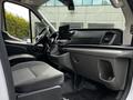 Interior view of a 2022 Ford Transit featuring two front seats a dashboard with a display screen and various controls