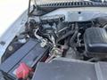The engine compartment of a 2013 Ford Expedition showing various components including the battery and hoses