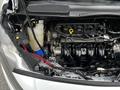 Engine compartment of a 2016 Ford Transit Connect showing the engine, coolant reservoir, and various components including wires and hoses