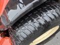 Close-up of a tire from a 2012 Kubota F3680 showing a thick tread pattern and a shiny surface