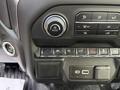 Dashboard controls of a 2024 Chevrolet Silverado 1500 including climate control knobs and various buttons for driving assist features