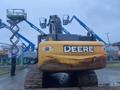 A 2014 John Deere 350G excavator with a yellow body and large tracks is positioned in the foreground