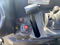 Close-up of the control panel in a 2018 Kubota RTV-X 1100 C featuring various buttons a gear shifter and a lever