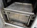 A metal sliding drawer inside the cargo area of a 2016 Ford F-550 designed for storage or refrigeration