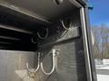 A close-up view of the interior hooks and metal fittings inside a 2011 Ford F-450 SD's cargo area