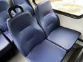 Two blue textured seats inside a vehicle with a simple design and a sleek appearance