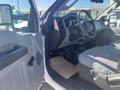 Interior view of a 2014 Ford F-250 SD showing the driver's side with steering wheel dashboard and seats