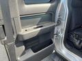 Interior door panel of a 2014 Ford F-150 featuring a handle armrest and storage compartment