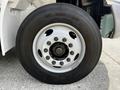 Close-up of a 2019 International 4300 truck wheel featuring a white rim with black lug nuts and a dark tire with visible tread patterns