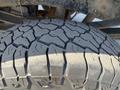 Close-up of a rugged tire tread on a 2014 Ford F-350 SD showcasing deep grooves and a durable design for off-road driving